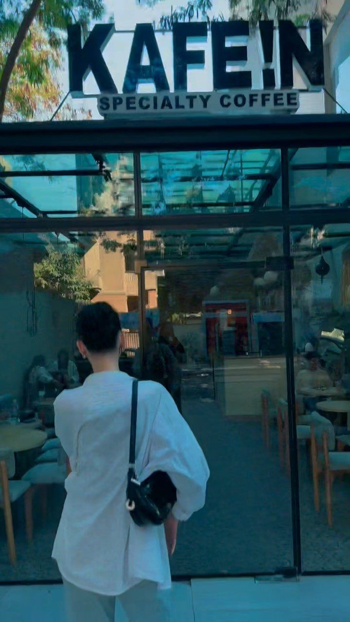 The KAFE !N Korba storefront: black steel and glass under the big black sign