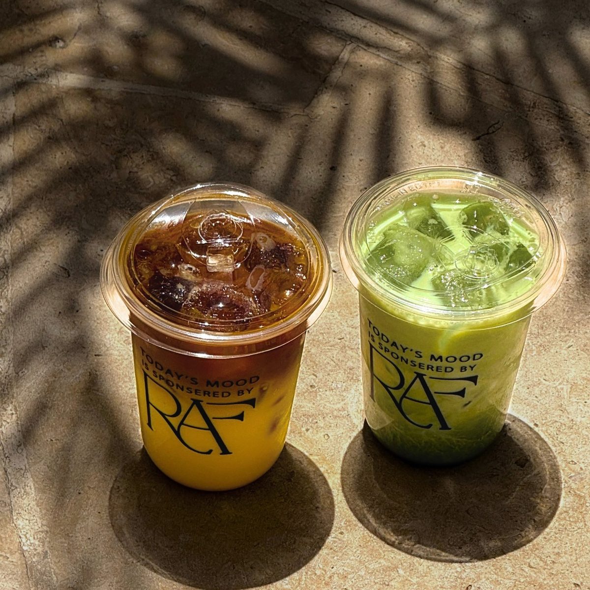 Two iced drinks in RAF cups printed with Today's mood, engineered by RAF